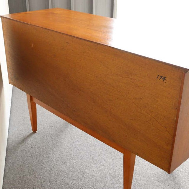 Compact British mid-century Jentique sideboard in vintage teak with clean wood grain and tapered legs from Denmark style.