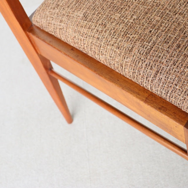 Mid-century vintage teak dining chair by McIntosh, British design with textured beige fabric seat and sleek wooden legs.