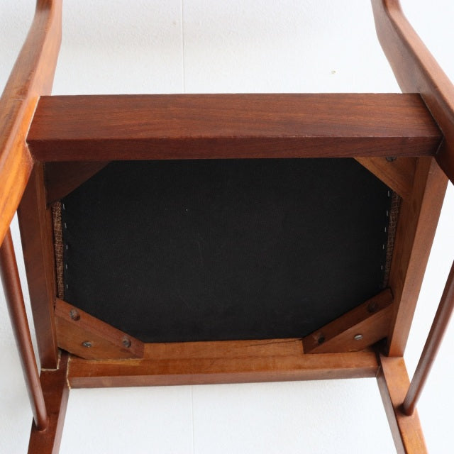 Vintage McIntosh teak dining chair underside showing British mid-century craftsmanship, solid wood frame, and sturdy joint.