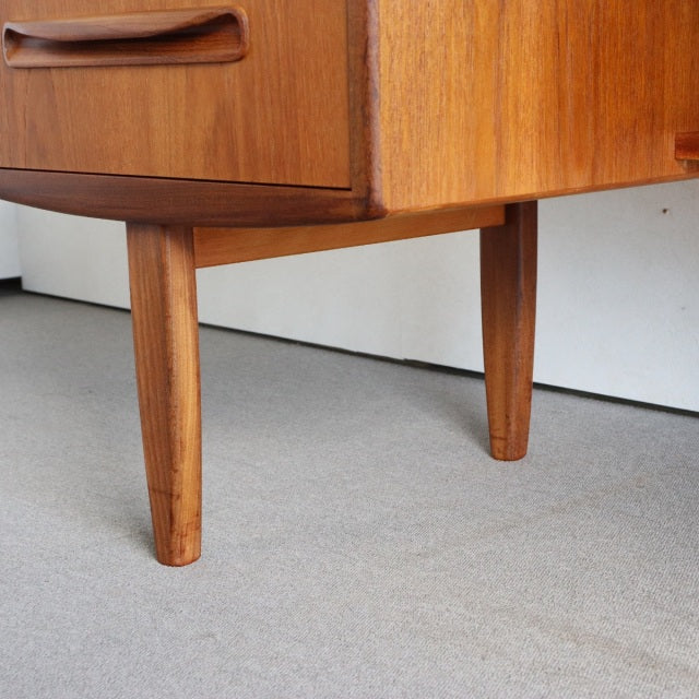 Mid-century British G-PLAN teak dresser legs with tapered design and warm wood grain finish.
