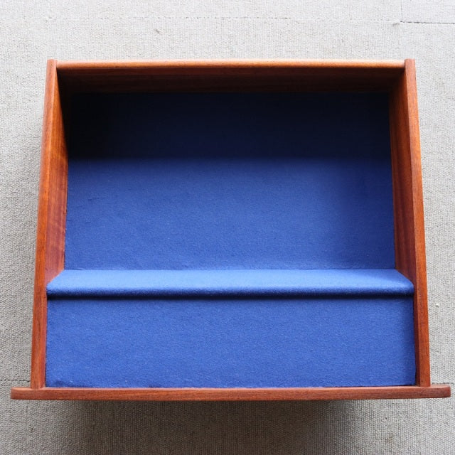 Vintage teak G-PLAN dresser drawer with smooth wood grain and navy blue velvet interior lining, mid-century British design.
