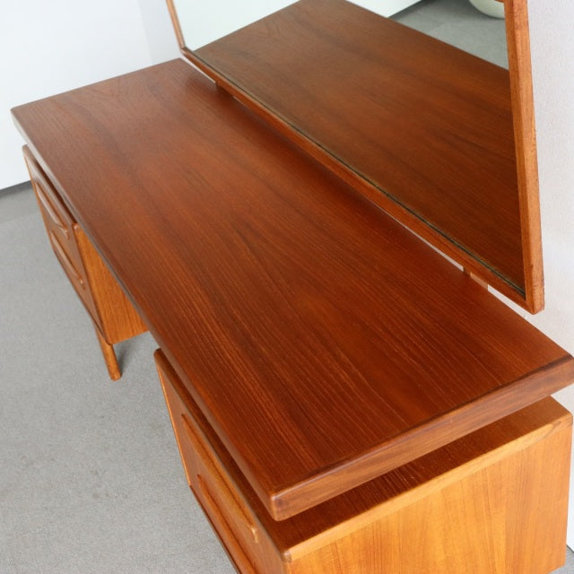 Vintage British mid-century G-PLAN teak dresser with rich wood grain, clean lines, and angled legs inspired by Danish design.