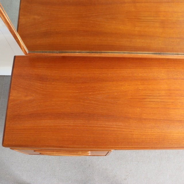 Vintage mid-century British G-PLAN teak dresser with rich wood grain and sleek edges, showing classic Danish-inspired.