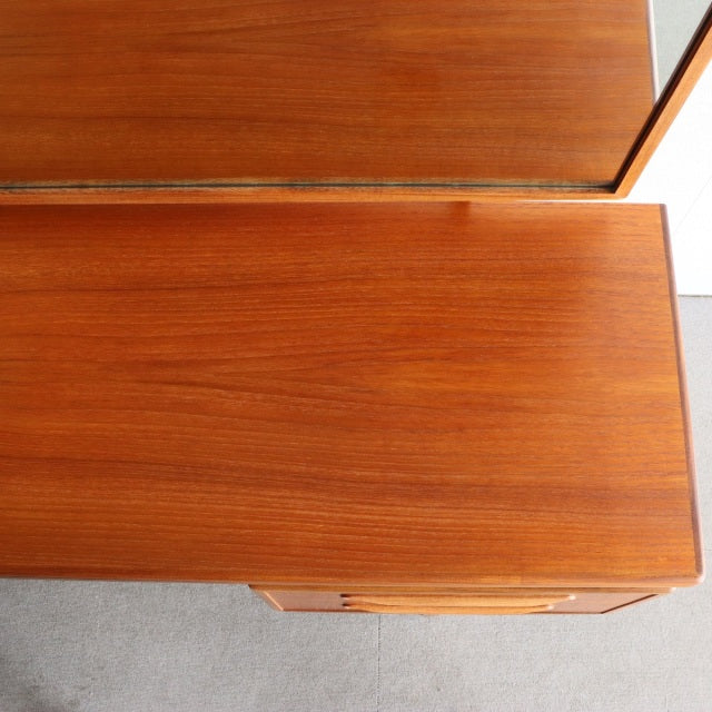 Vintage teak G-PLAN British mid-century dresser with smooth wood grain and clean lines, inspired by Danish design.