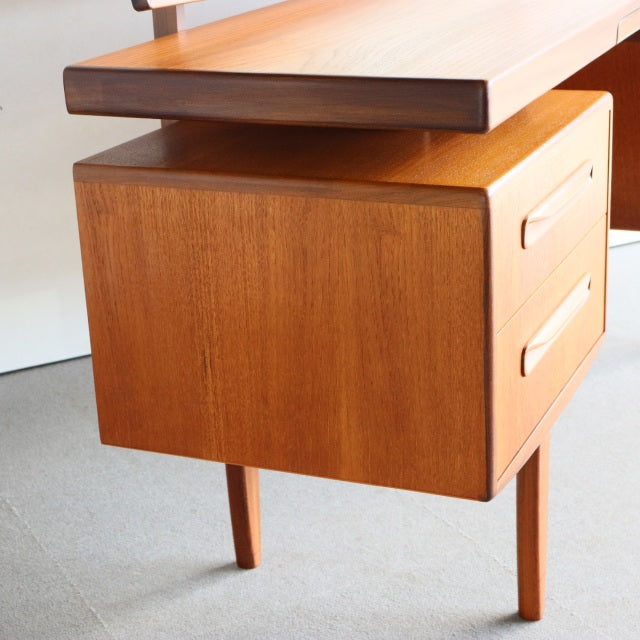 Vintage British mid-century teak G-Plan dresser with rich wood grain, clean lines, and slender tapered legs.