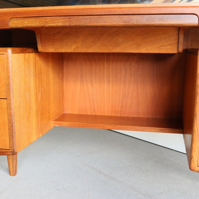 Vintage teak mid-century British G-PLAN dresser interior with smooth wood grain and curved edges.
