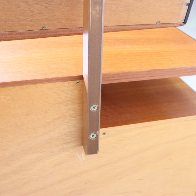 Close-up of vintage teak G-Plan dresser showcasing mid-century British craftsmanship, smooth wood grain, and sturdy support.