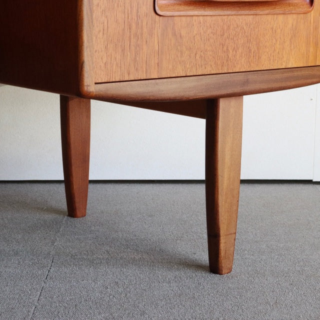 Mid-century British G-PLAN dresser legs in warm teak with smooth wood grain and tapered form from Denmark design tradition.