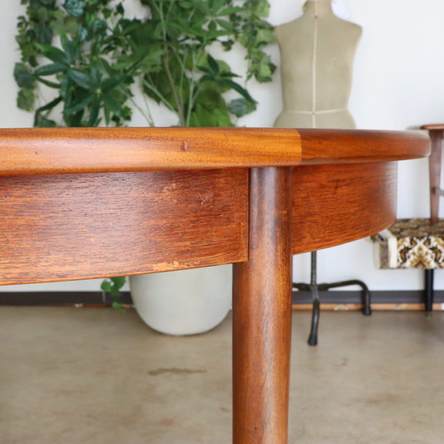 Vintage teak G-Plan mid-century dining table leg and apron detail showcasing smooth wood grain and British craftsmanship.