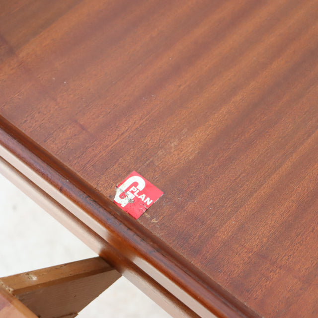 Vintage G-Plan teak dining table corner showing rich wood grain and mid-century British design label.