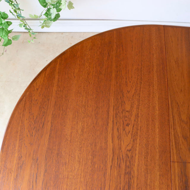 Vintage G-Plan teak dining table top with rich wood grain and rounded edges, British mid-century design.