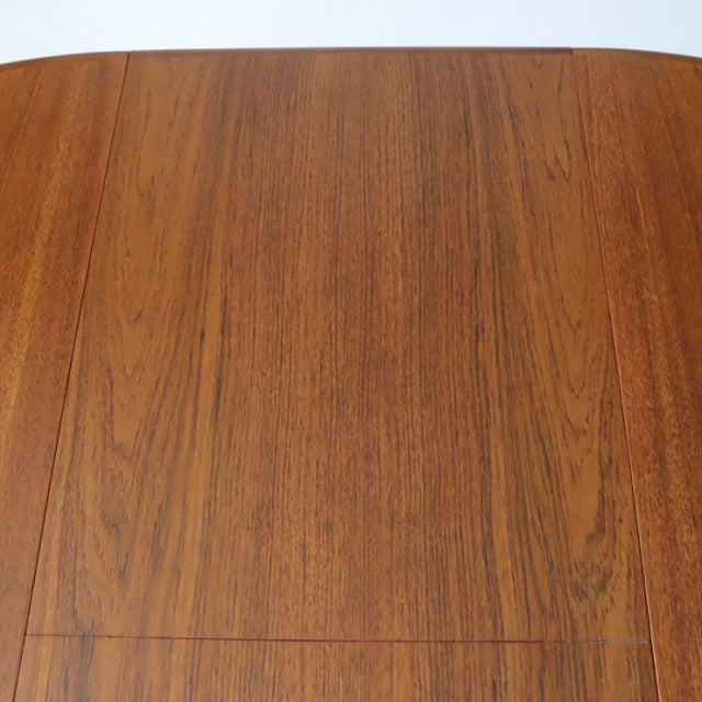 Vintage G-Plan mid-century teak dining table with rich wood grain and rounded corners.