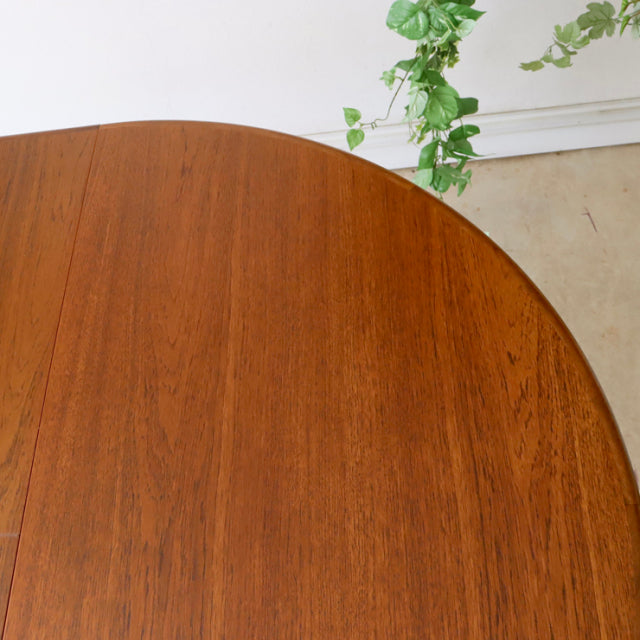 Vintage mid-century teak G-Plan dining table with rich wood grain and rounded edge, British design inspired by Denmark style.