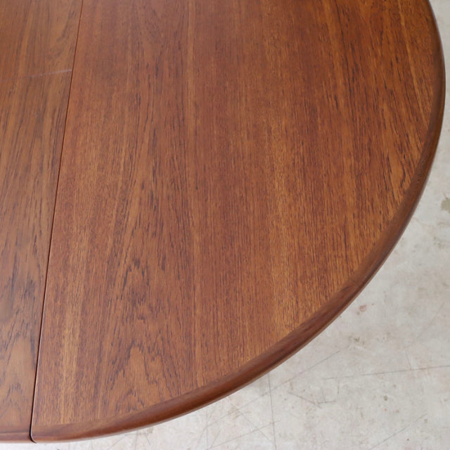 Round vintage teak dining table top with rich wood grain, classic British mid-century design by G-PLAN from Denmark.