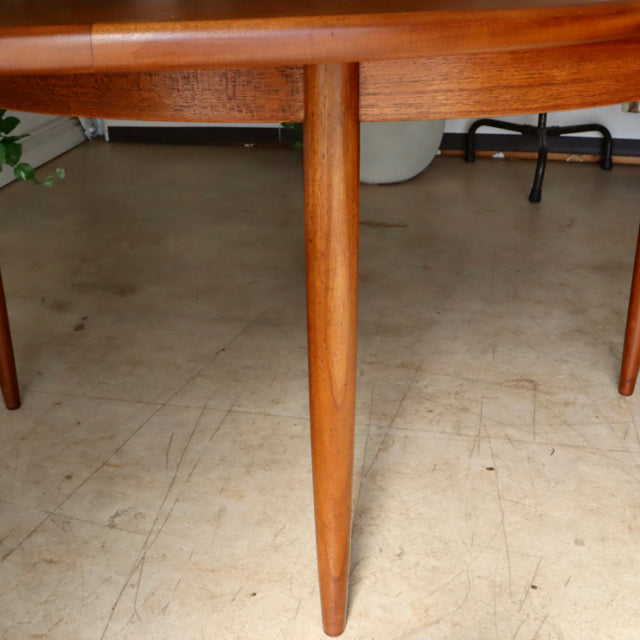 Mid-century vintage G-Plan teak dining table leg showing warm wood grain and tapered British Scandinavian design.