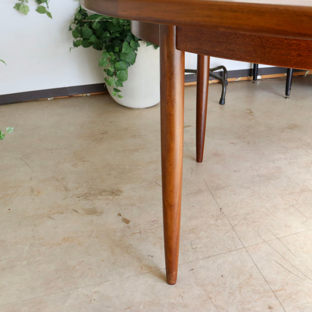 Mid-century British G-Plan vintage teak dining table with tapered round legs and smooth wood grain finish.