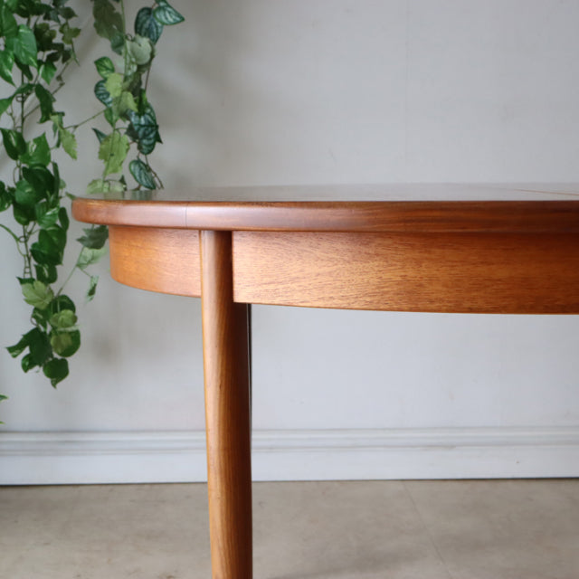 Vintage teak G-Plan mid-century dining table with rounded edges and tapered British-style legs.