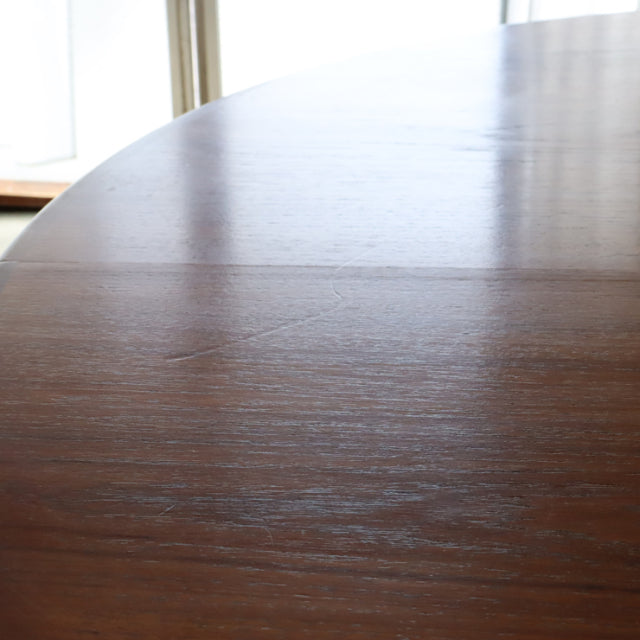 Oval mid-century vintage teak dining table by British brand G-Plan with smooth wood grain and elegant rounded edges.