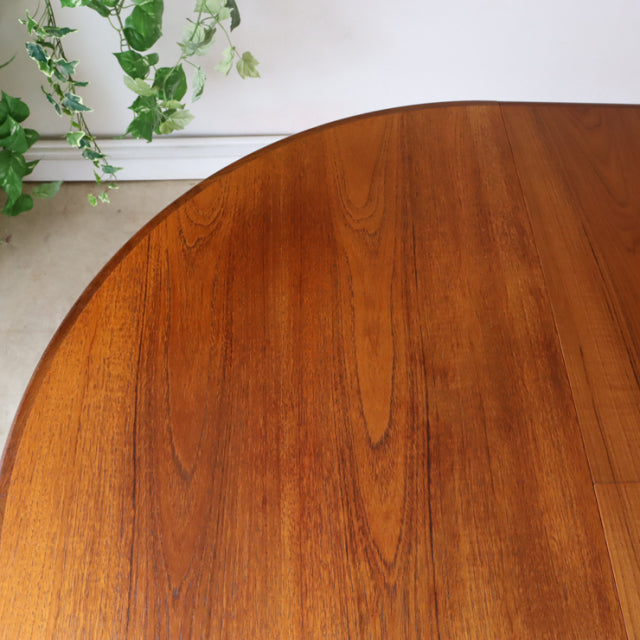 Vintage G-Plan mid-century British teak dining table with rich wood grain and smooth rounded edge.