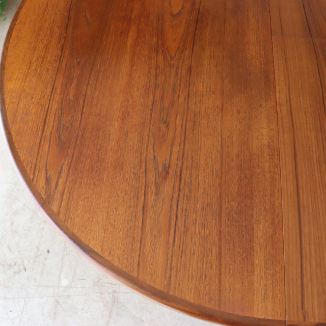 Mid-century vintage G-Plan teak dining table with rich wood grain and rounded edge, British design influences from Denmark.