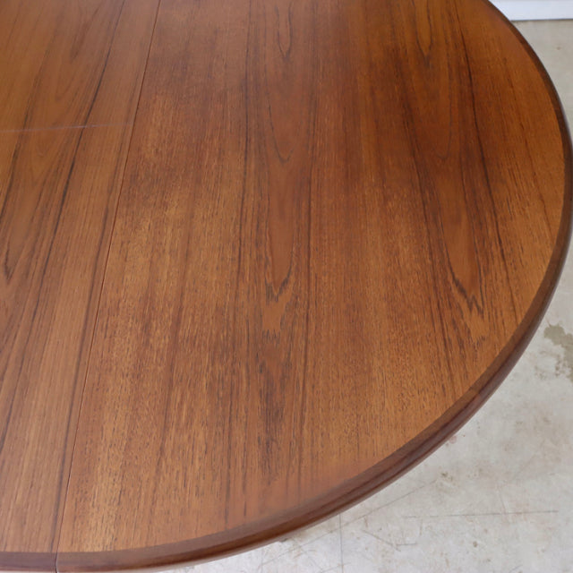 Round vintage teak dining table with rich wood grain and smooth edges, mid-century British G-PLAN design.