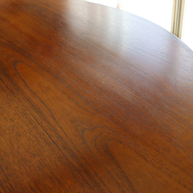 Vintage British mid-century G-Plan teak dining table with smooth wood grain and oval top.
