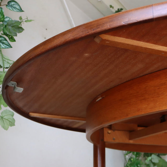 Vintage teak G-Plan dining table underside showing British mid-century craftsmanship with sturdy legs and smooth wood grain.