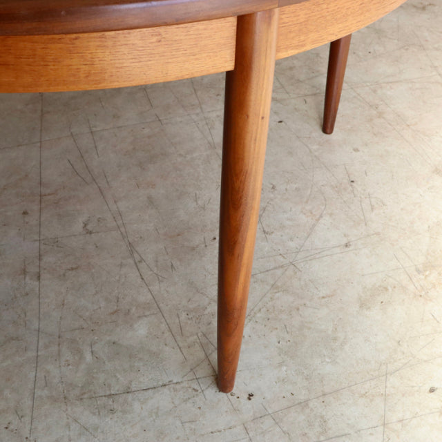 Mid-century British G-Plan dining table leg in vintage teak with smooth wood grain and tapered design.