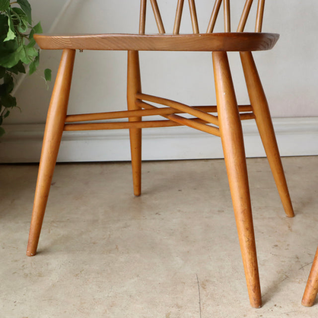 Vintage teak ERCOL X-Back chair leg detail with tapered round legs and mid-century British design.