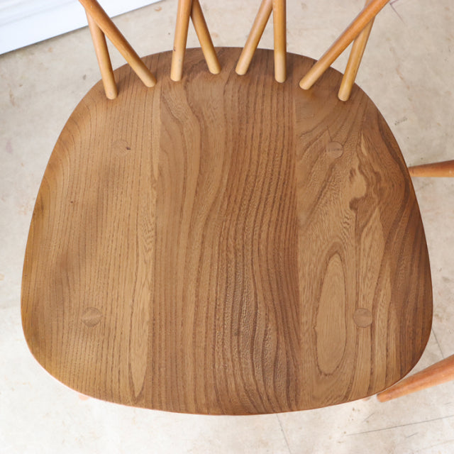 Vintage teak mid-century ERCOL X-Back chair seat showing rich wood grain and smooth finish.