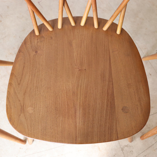 Vintage teak ERCOL X-Back Chair seat showcasing smooth wood grain and rounded edges, mid-century British design from Denmark.