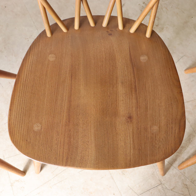 Vintage teak ERCOL X-Back Chair seat showing smooth wood grain and curved edges from British mid-century Denmark-inspired.