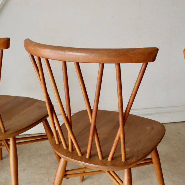 Vintage teak ERCOL X-Back chair with angled spindles, tapered legs, mid-century British design.