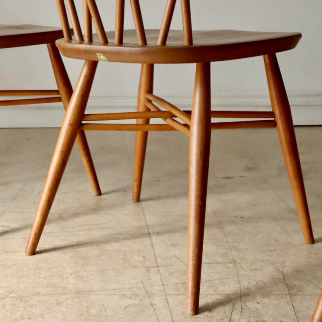 Vintage teak ERCOL X-Back chair with slender tapered legs and classic mid-century British design.