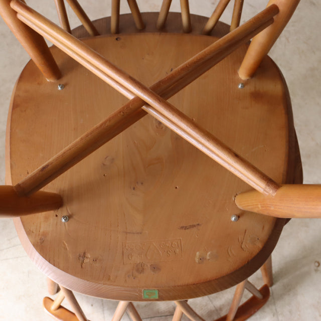 Vintage teak ERCOL X-Back chair with mid-century British design, visible wood grain, sturdy crossed legs, and smooth seat.