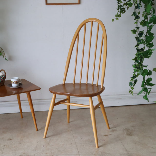 Vintage Ercol Quaker chair in mid-century British teak with spindle back and tapered legs.
