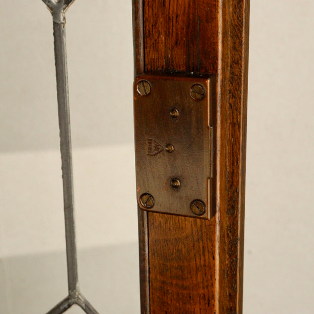 Close-up of brass hinge on vintage teak wood leg of British mid-century Jaycee cabinet from Denmark.