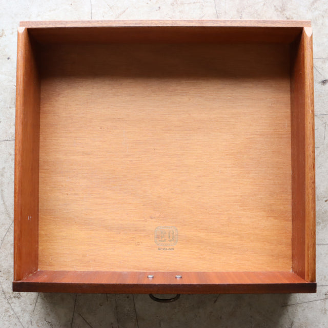 Vintage teak drawer from British mid-century G-Plan bedside cabinet, showing natural wood grain and original stamp.