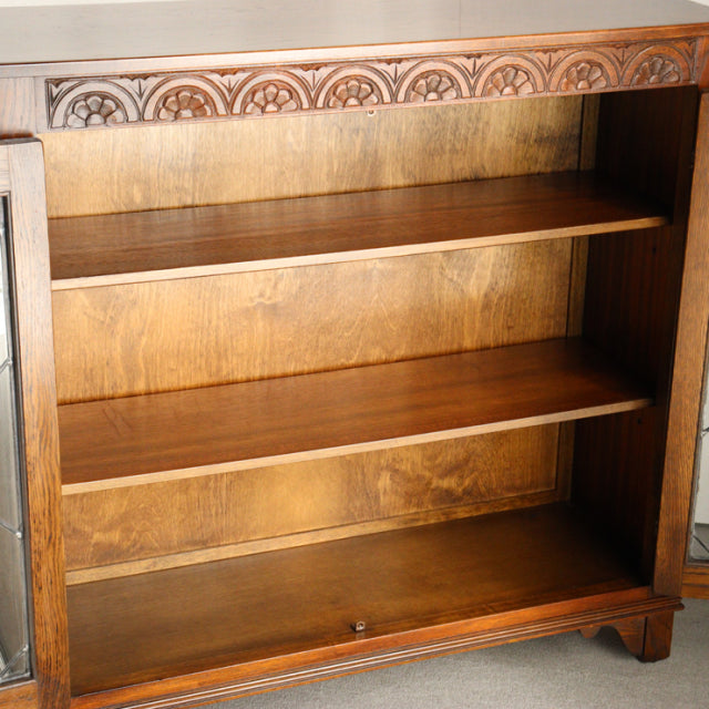 Vintage teak Jaycee cabinet with mid-century British design, detailed wood grain, two shelves, carved top trim.