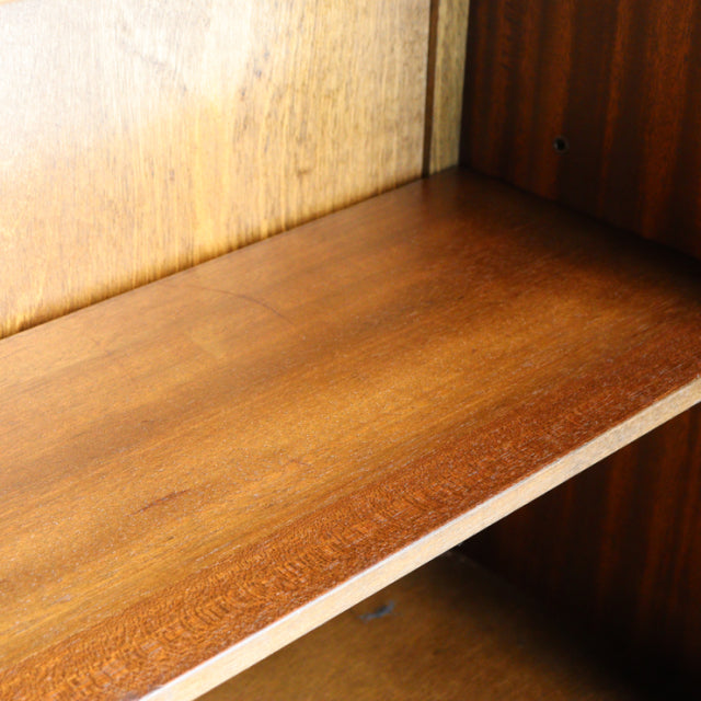 Close-up of vintage teak wood cabinet shelf with smooth grain, mid-century British design by Jaycee.
