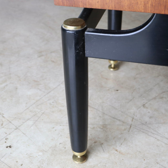Black tapered wooden leg with brass cap and base detail from vintage British mid-century teak furniture.
