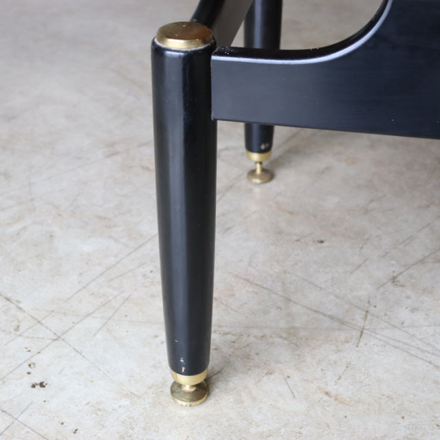 Black tapered wooden leg with brass cap and mid-century teak British vintage design detail.