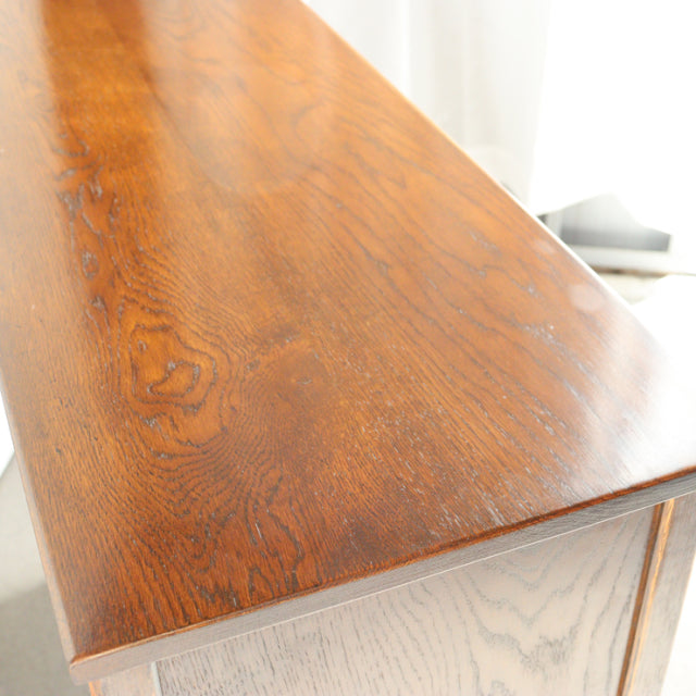 Vintage teak wood cabinet top with deep grain patterns, smooth mid-century British design.
