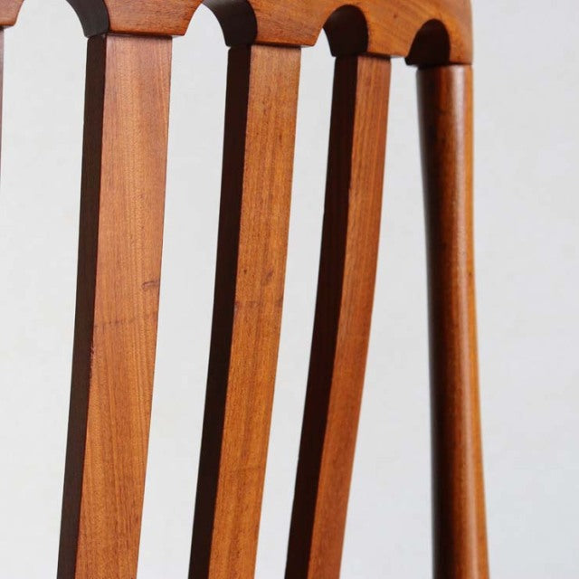 Vintage Meredew teak dining chair backrest with slender vertical slats and smooth British mid-century craftsmanship from.
