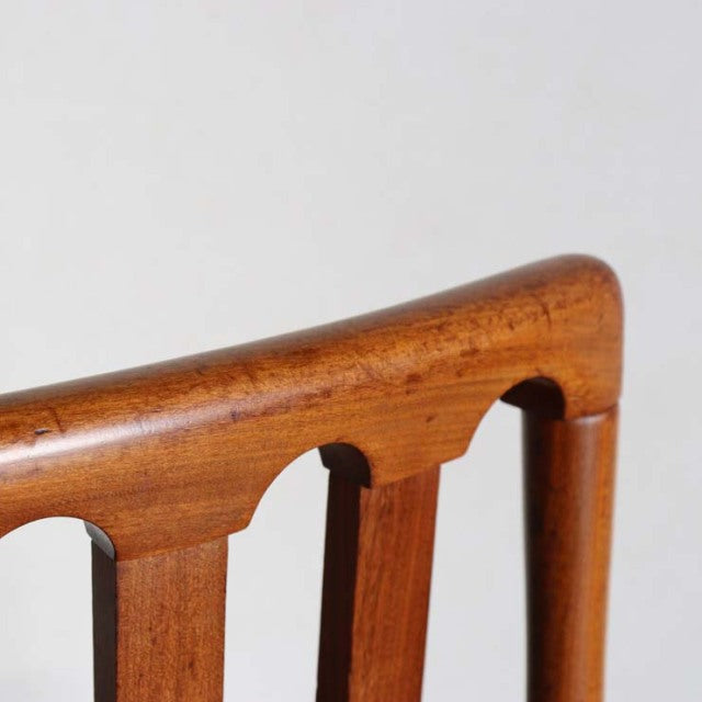 Mid-century vintage teak dining chair backrest showing warm wood grain and smooth rounded edges from British Meredew brand.