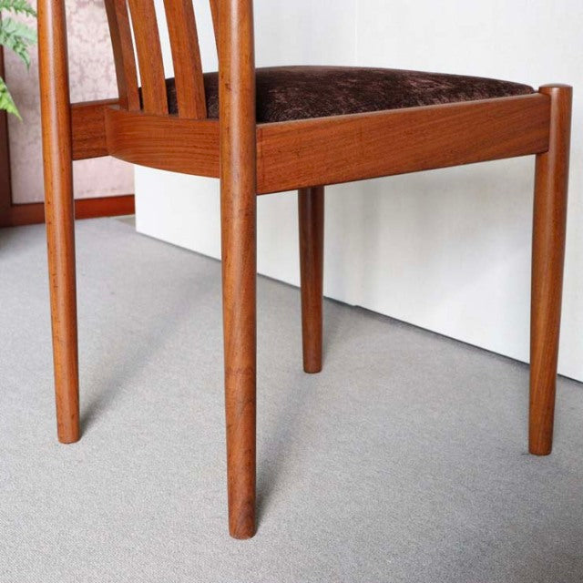 Mid-century teak dining chair by Meredew with slender legs and rich wood grain, British-Danish vintage style.
