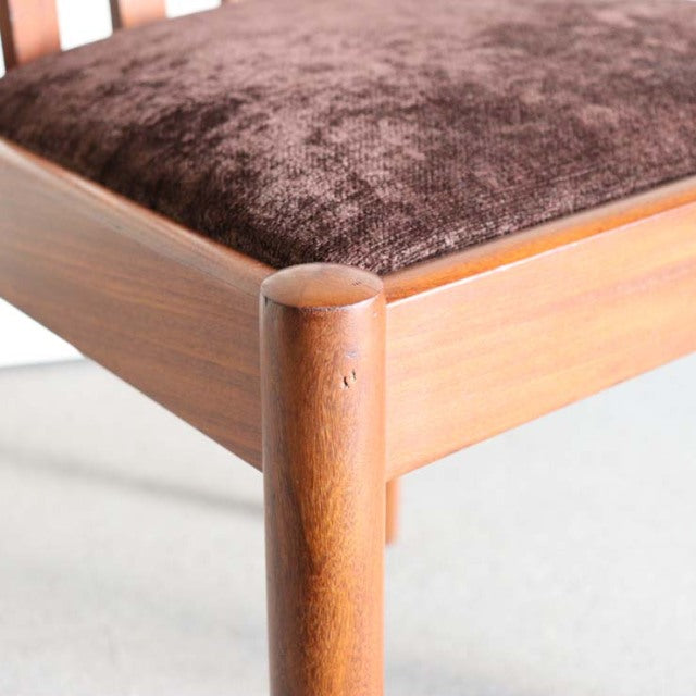 Vintage teak dining chair leg with smooth rounded edges and rich wood grain from mid-century British design.