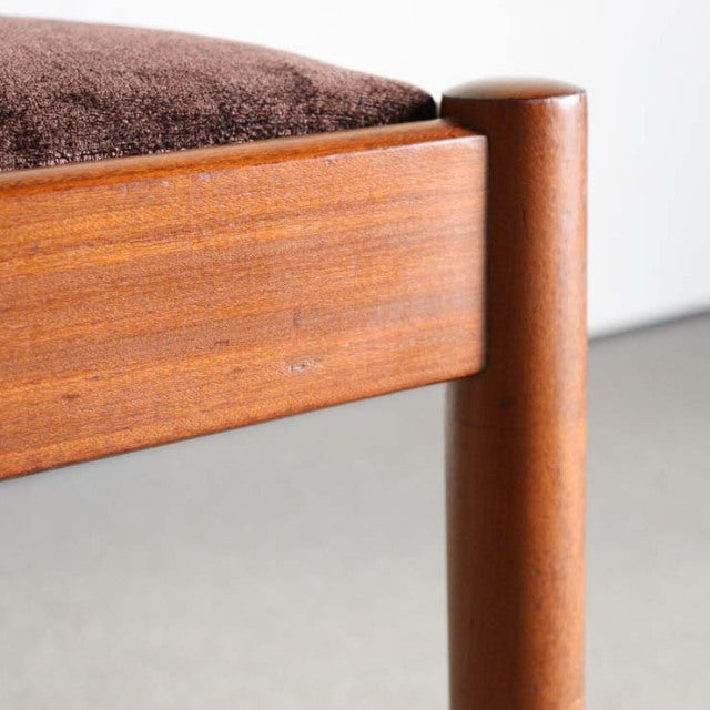 Close-up of vintage Meredew teak dining chair leg and frame showcasing smooth wood grain and mid-century British design from .