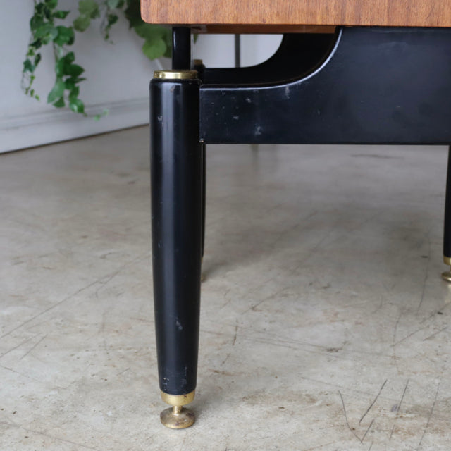 Mid-century British teak bedside cabinet with black tapered leg and brass capped foot, showcasing vintage G-PLAN design.