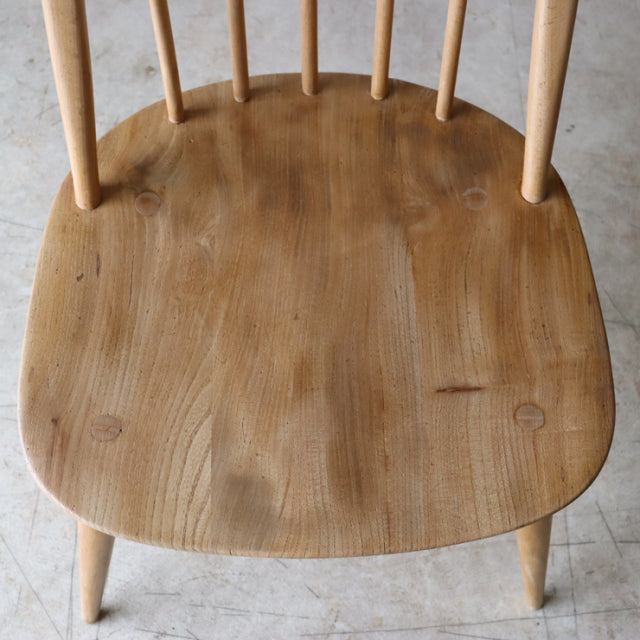 Natural teak vintage Ercol Quaker chair seat with smooth wood grain and rounded edges, British mid-century design from.